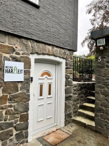 a white door on the side of a stone building at Meine HarzZeit in Goslar