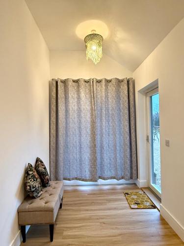 a living room with a couch and a window at Bespoke 1 Bedroom Barn by Stansted Airport & Holiday Parking in London Stansted Airport