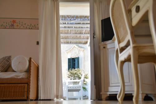 a view of a bedroom with a bed and a window at Relais Corte Palmieri & Il Chiostro - Residenza d'epoca in Gallipoli
