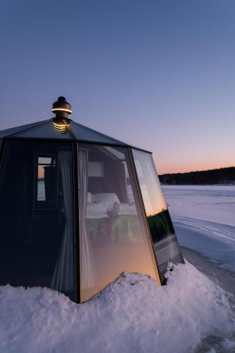 a tent in the snow with a bedroom in it at Nova Galaxy Village in Rovaniemi