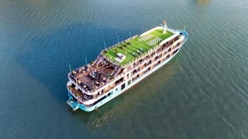 a large cruise ship in the water at Dragon Premium Cruise Halong in Ha Long