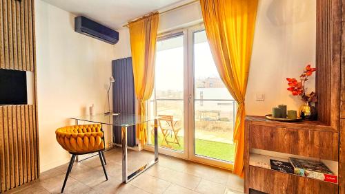 a dining room with a glass table and a window at Vision Luxury Marina in Wrocław