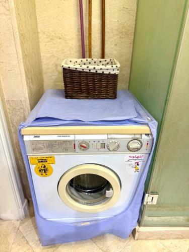 a washing machine with a basket on top of it at Exquisite 1BR Chalet with Pool and Beach Front El Gouna in Hurghada