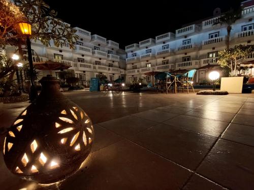 a large building with a vase in front of it at Zak Inn in Hurghada