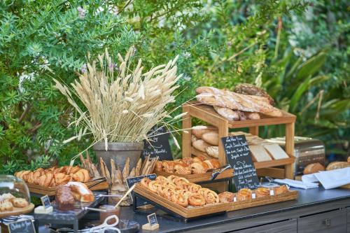 a table with different types of bread and pastries at Grand-Hôtel du Cap-Ferrat, A Four Seasons Hotel in Saint-Jean-Cap-Ferrat