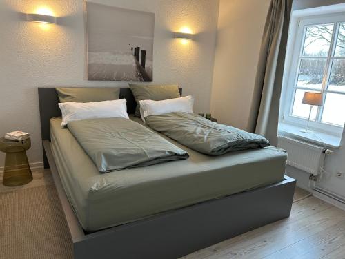 a bed with two pillows on it in a bedroom at Ferienwohnung 1 Hof Flüh in Klenzau