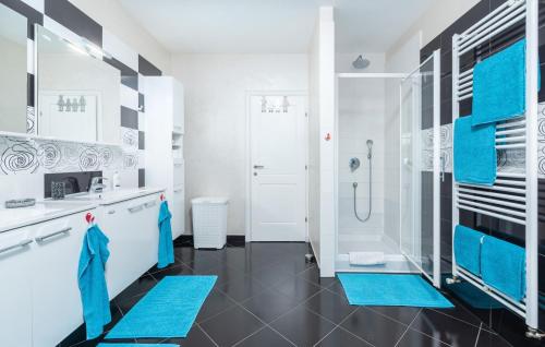 a bathroom with a shower and blue mats at Villa St. Anna in Radetići - Haus für 8 Personen in Radetići