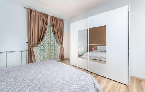 a bedroom with a bed and a large window at Villa St. Anna in Radetići - Haus für 8 Personen in Radetići