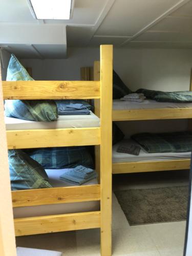 two wooden bunk beds in a room at Harzbett in Sinsleben