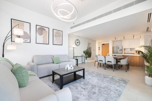 a living room with a couch and a table at La Vie in JBR! Private Beach! Excellent Apartments! in Dubai