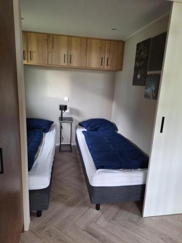 Postel nebo postele na pokoji v ubytování Woodlonge Tinyhouse