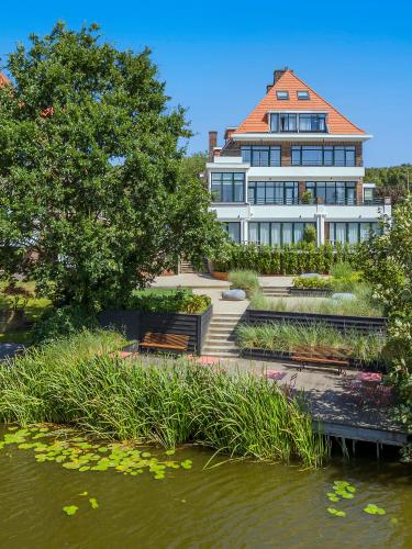 a large white building next to a body of water at By Friso Den Haag - Scheveningen in Scheveningen