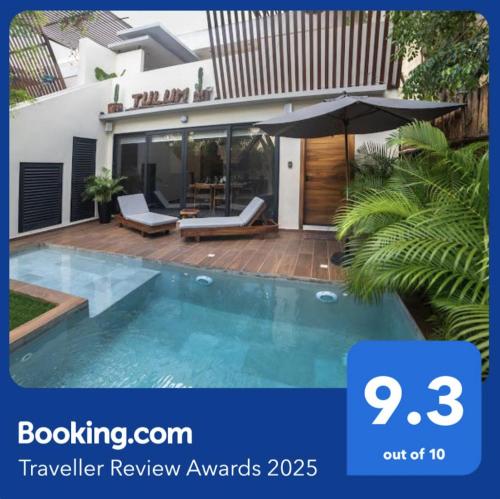 a swimming pool in front of a house at Villa Paradise Tulum Veleta 4BR private pool & jacuzzi in Tulum