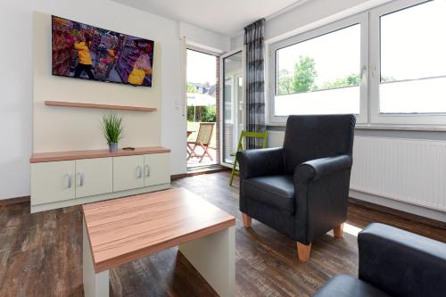 a living room with a chair and a table at Zur Möwe 5 in Esens