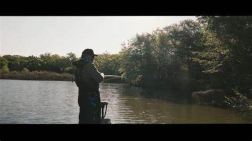 a man standing in front of a body of water at Studio 6 Suites Perry, GA in Perry