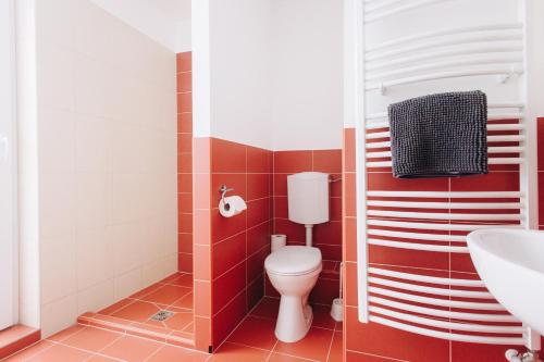 a bathroom with a toilet and a sink at Rooftop City Residence with Underground Parking in Budapest