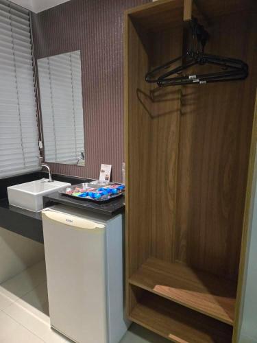 a bathroom with a sink and a counter top at Hotel Alfama Motel in Salvador