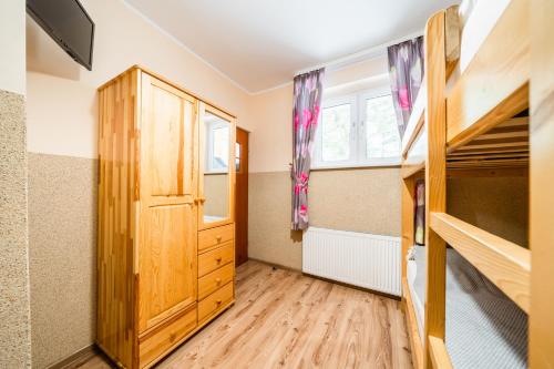 a bedroom with two bunk beds and a window at Schronisko PTTK Orlica in Szczawnica