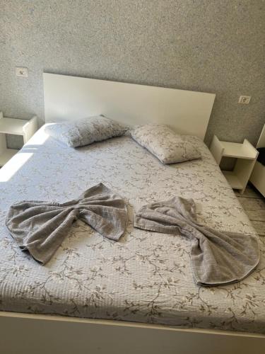 a bed with a blanket and pillows on it at Amalya in Constanţa