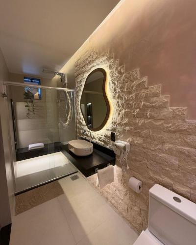 a bathroom with a sink and a stone wall at Cirandeira Amazon World EcoResort in Manacapuru