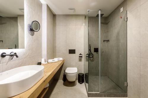 a bathroom with a sink toilet and a shower at Blue Star Luxury Hotel in Sofia