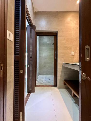 a bathroom with a door and a walk in shower at Villa sun in Amphoe Koh Samui