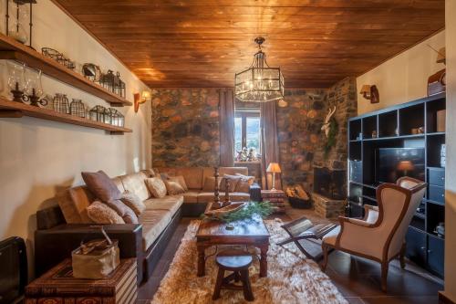a living room with a couch and a table at Dandy Villas Palios Agios Athanasios - Rustic - Fireplace - Village Square in Palaios Agios Athanasios