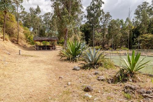 a park with a pavilion next to a body of water at Taz's house in Hacienda Yacucalle