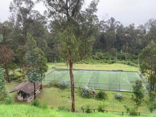 an aerial view of a tennis court at Taz's house in Hacienda Yacucalle