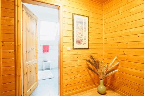 a wooden hallway with a vase with a plant in it at Modernes Ferienhaus mit Kamin & Garten in ruhiger Lage in Hasselfelde