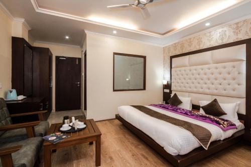 a bedroom with a large bed and a living room at HUKAM'S HOLIDAY HOME by HHH in Kasol