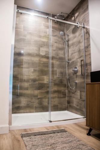a shower with a glass door in a bathroom at Kabin Kamouraska 1 in Rivière-Ouelle