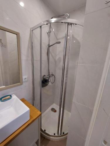 a shower in a bathroom with a sink at Studio Casa Tropicana in Paul do Mar