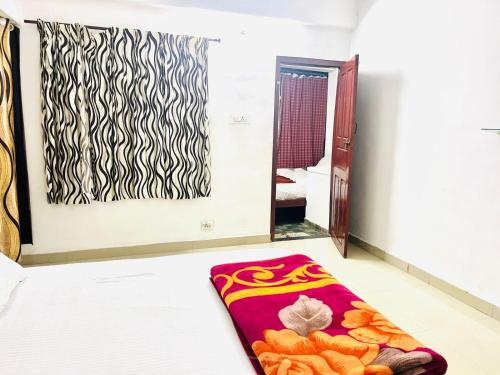 a room with a bed with a rug on the floor at GlenBrook HomeStay in Munnar