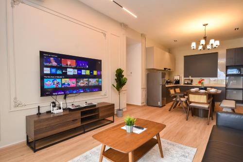 a living room with a large flat screen tv on a wall at Country Garden Seaview Suite by Nest Home at Danga Bay in Johor Bahru
