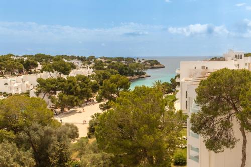 a view of a beach and the ocean from a building at Sentido Fido Tucan - Adults Only in Cala d´Or