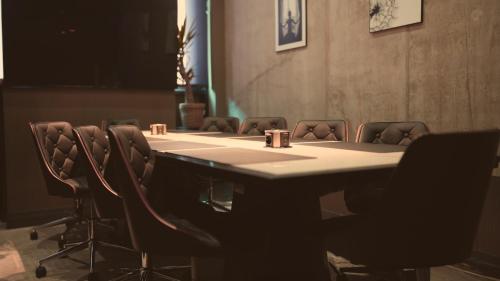 a conference room with a long table and chairs at Bellman Hotel in Berlin