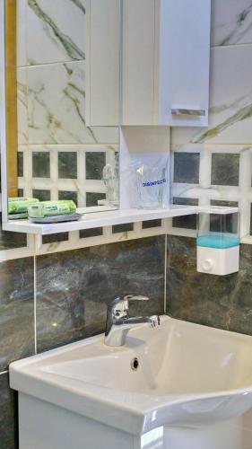 a bathroom with a sink and a mirror at Apartments Pravica Trebinje in Trebinje