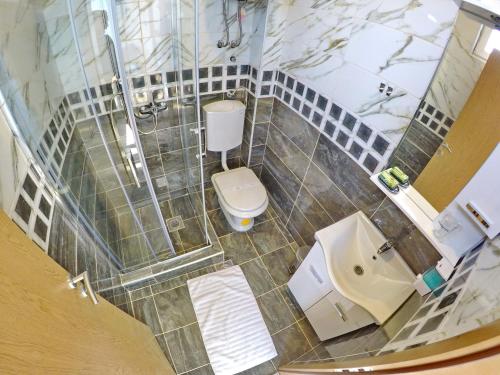an overhead view of a bathroom with a toilet and sink at Apartments Pravica Trebinje in Trebinje