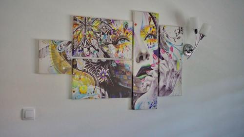 a group of three paintings hanging on a wall at Apartments Pravica Trebinje in Trebinje