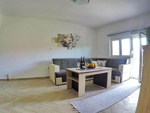 a living room with a couch and a table at Apartments Pravica Trebinje in Trebinje