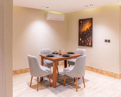 a dining room with a table and chairs at Medad Apartments Al Hamra in Al Khobar