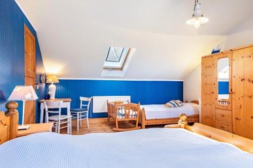 a bedroom with two beds and a table and a dining room at Ferienhaus Bondelum in Bondelum