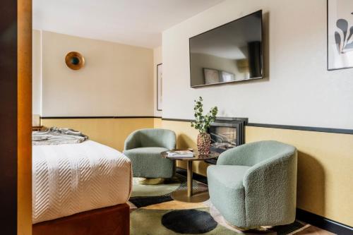 a bedroom with two chairs and a table and a bed at Colette - LoftAffair Collection in Warsaw