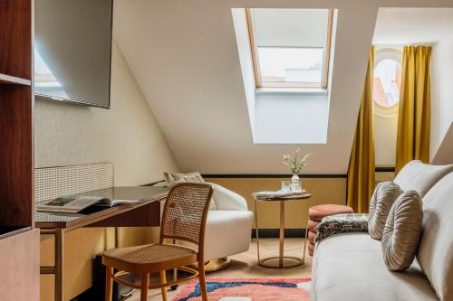 a room with a desk and a couch at Colette - LoftAffair Collection in Warsaw