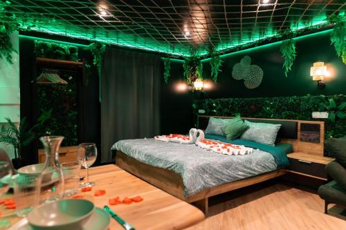 a bedroom with a bed and a table with food on it at L'Oasis Tropicale, Jacuzzi, Love Room in Roppenheim