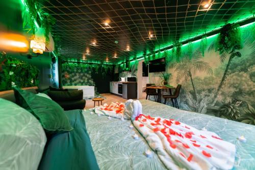 a bedroom with two beds and green lights at L'Oasis Tropicale, Jacuzzi, Love Room in Roppenheim