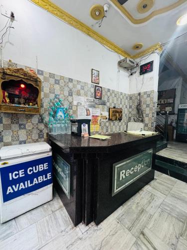 a restaurant with a counter in a room at Hotel Hari Ganga - Harkipauri Road in Haridwār