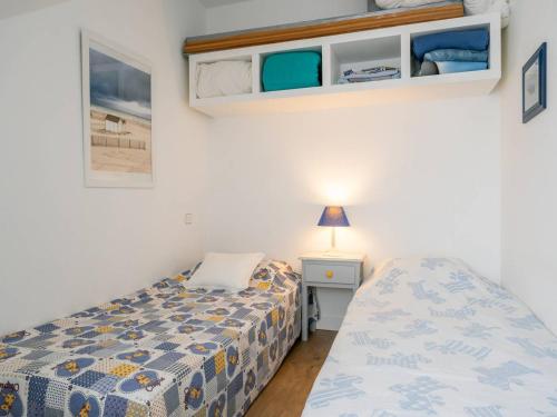 - une petite chambre avec un lit et une petite table dans l'établissement Appartement lumineux à Carnac, 500m des plages, 2 chambres, parking - FR-1-477-183, à Carnac