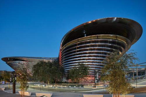 a building with a domed roof with trees in front at Cheval Maison - Expo City Dubai in Dubai